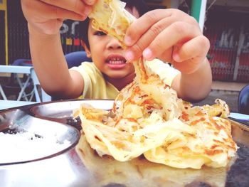 Close-up of boy eating ice cream in plate