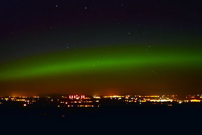 Illuminated city against sky at night