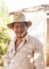 Man wearing hat standing outdoors