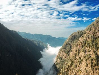 Scenic view of clouds amidst mountains