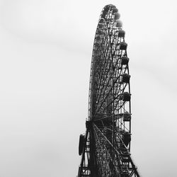 Low angle view of ferris wheel against sky