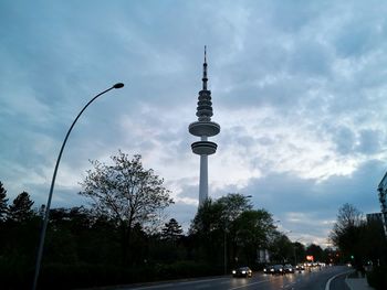 Street by road against sky in city