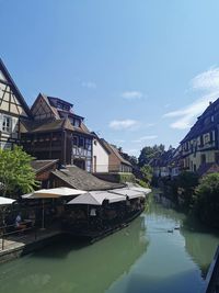 Canal amidst buildings against sky