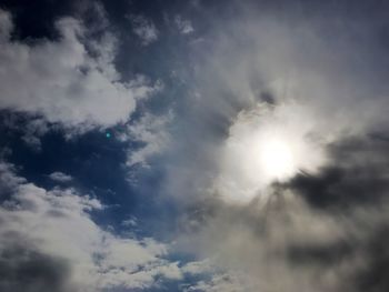 Low angle view of sun shining in sky