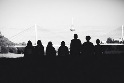 Silhouette people against sky