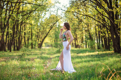 Side view of a woman standing on field