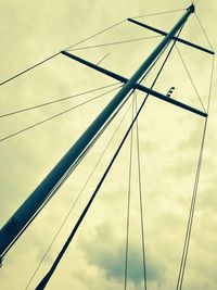 Low angle view of electricity pylon against sky