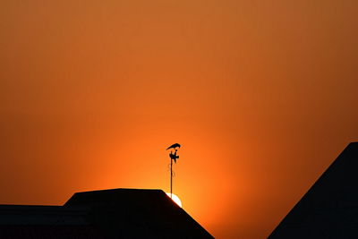 Low angle view of built structure at sunset