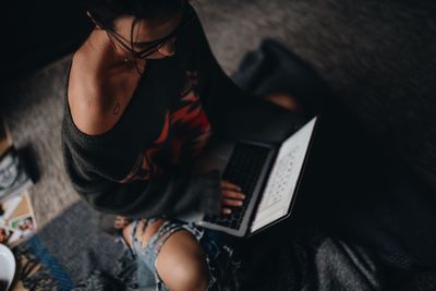 Woman using laptop while siting at home