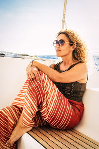 Young woman wearing sunglasses sitting outdoors