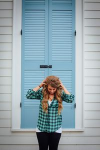 Portrait of woman standing by railing