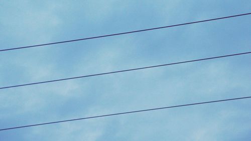 Low angle view of cables against sky