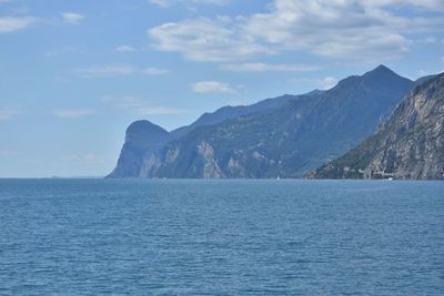 Scenic view of sea and mountains against sky