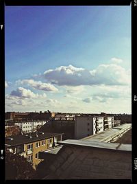 Buildings against cloudy sky