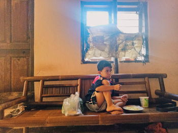 Girl sitting on table at home