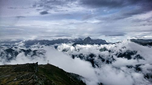 Scenic view of mountains against cloudy sky