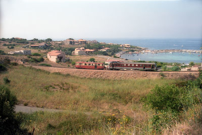 Passenger train at coastline of corse island in direction of calvi .