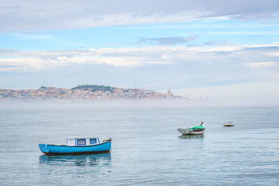 Boats in sea against sky