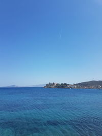 Scenic view of sea against clear blue sky