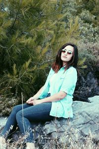 Portrait of smiling young woman sitting outdoors