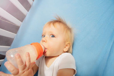 Portrait of cute baby boy eating food