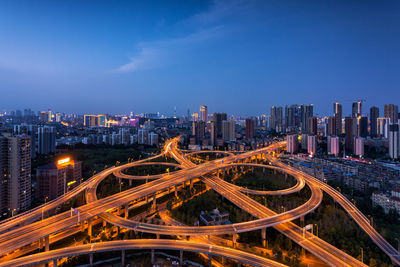 High angle view of city lit up at night