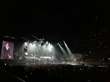 Crowd at illuminated music concert at night