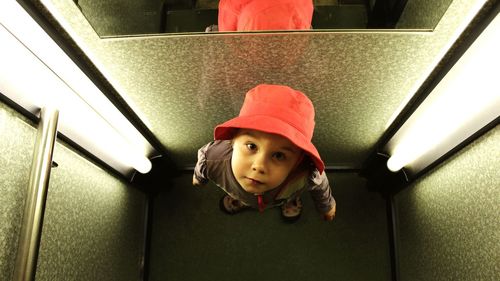 Directly above shot of boy standing in elevator