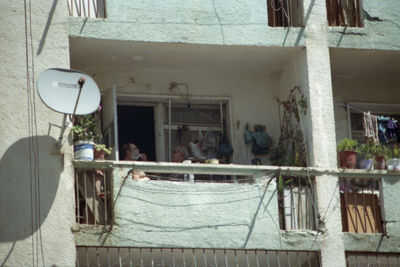 Low angle view of people on window of building