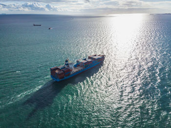 High angle view of boat sailing on sea against sky