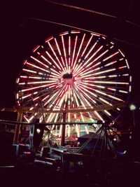 Low angle view of ferris wheel at night