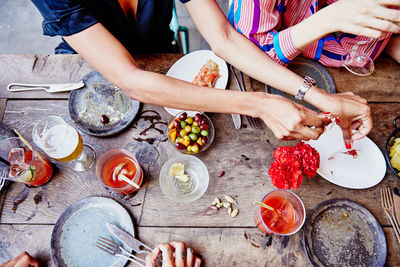 High angle view of people preparing food on table