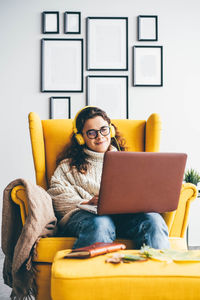 Young woman using laptop at home