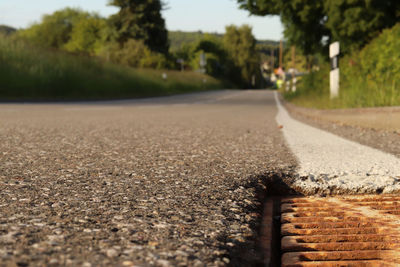 Surface level of road against sky in city