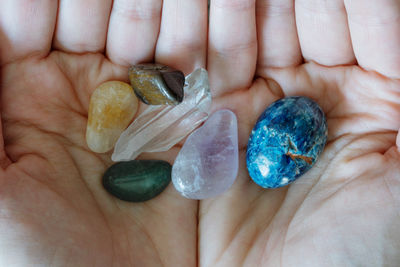 Hands holding colorful crystals