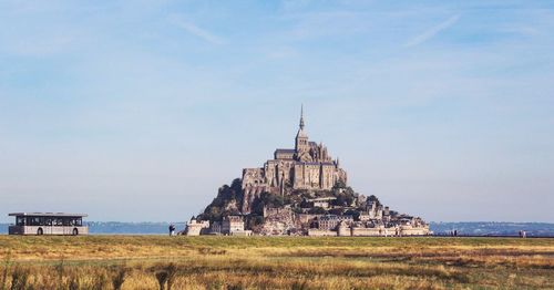 Mont saint michel on field against sky