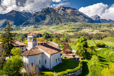 Houses and buildings on mountain against sky