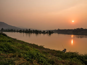 Scenic view of lake against sky during sunset