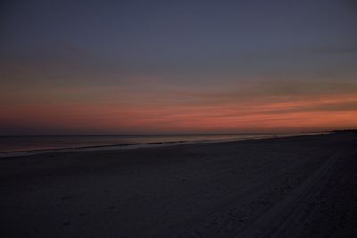 Scenic view of beach against sky during sunset