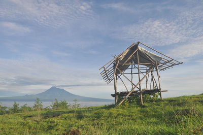 The old hut stands with the background of mount merapi.