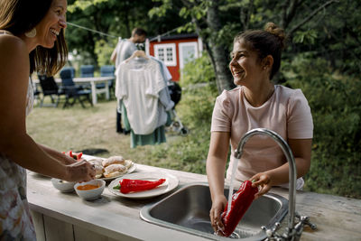 Woman holding ice cream standing outdoors