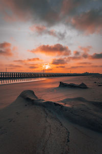 Scenic view of beach against sky during sunset