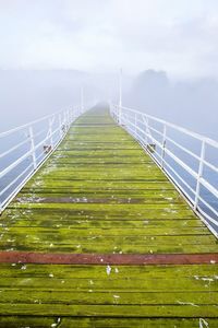 View of suspension bridge over sea against sky