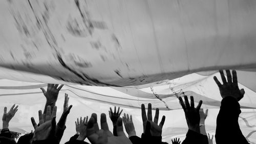 Crowd with arms raised at music concert