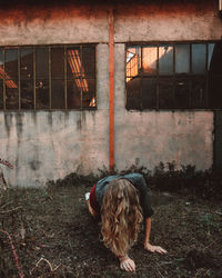 Rear view of woman with dog on window