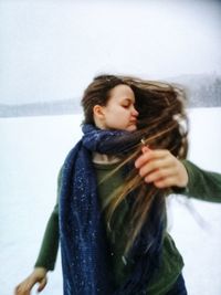 Close-up of beautiful woman standing in snow