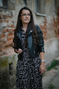 Attractive bussineswoman with leather jacket and glasses smiling