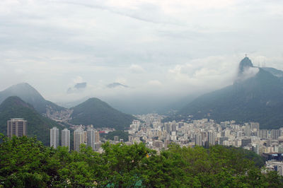 High angle view of buildings and mountains against sky