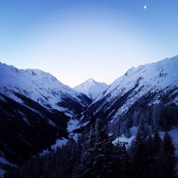 Scenic view of snow covered mountains against clear sky