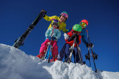 People skiing on snow covered landscape